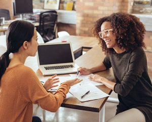 Two colleagues talking in office